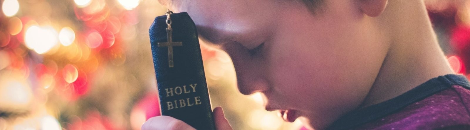 child holding bible
