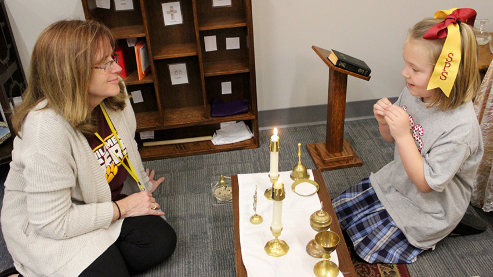 teacher and child learning about catholicism